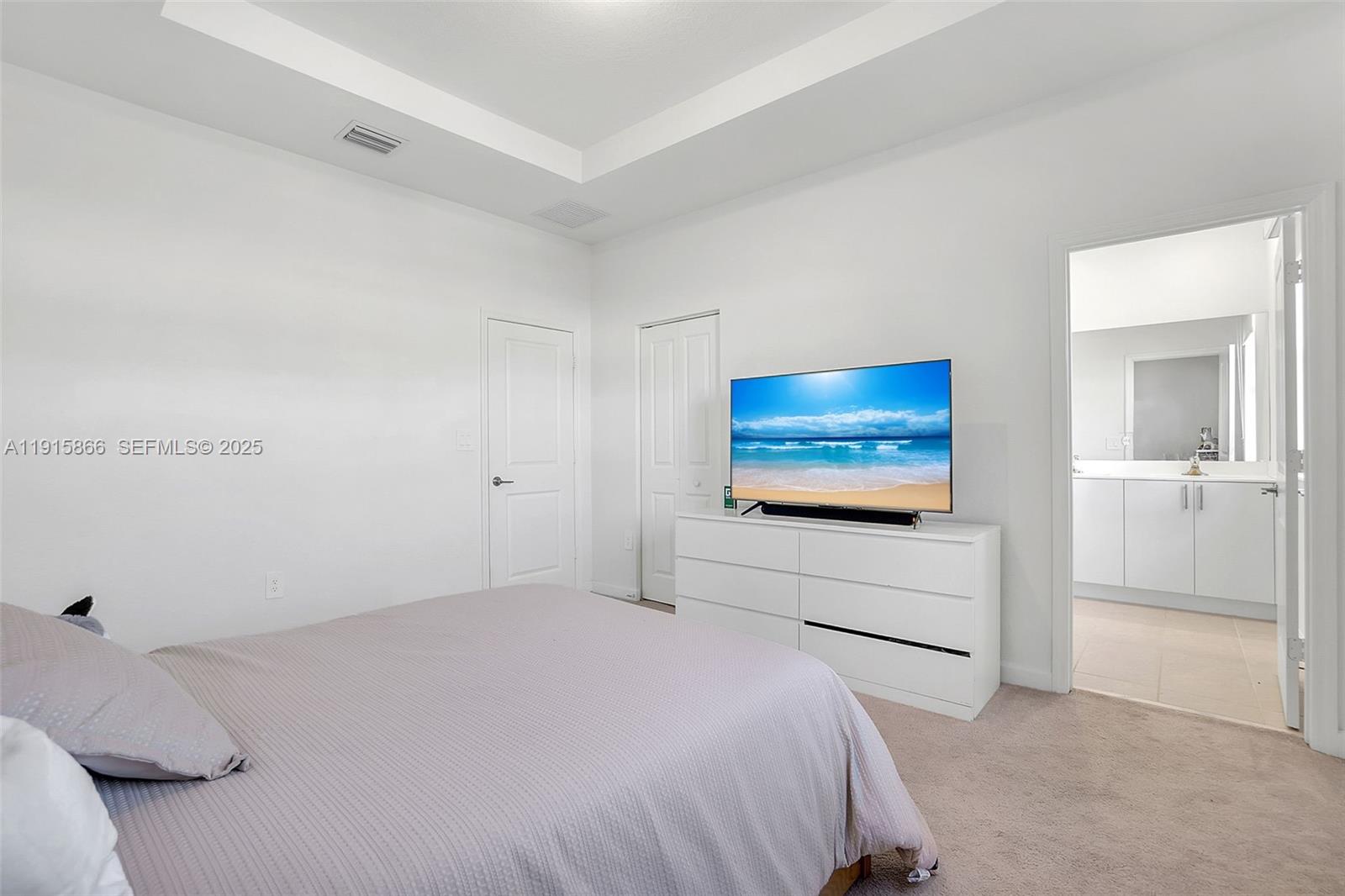 12859 Southwest 243rd Terrace Homestead, FL 33032 - Photo 18 of 38 a bedroom with a bed and a flat screen tv