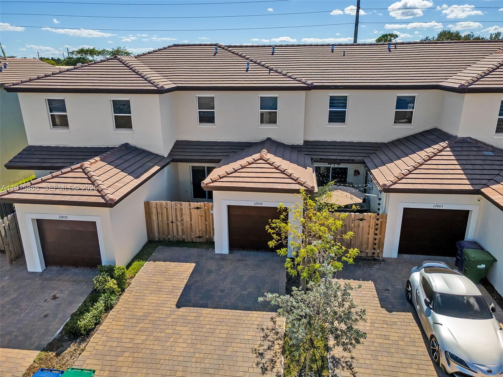 12859 Southwest 243rd Terrace Homestead, FL 33032 - Photo 2 of 38 a front view of a house with garden