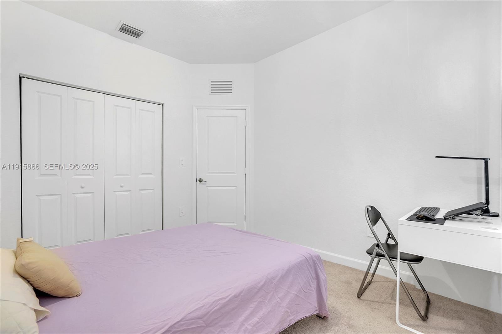 12859 Southwest 243rd Terrace Homestead, FL 33032 - Photo 22 of 38 a bedroom with a bed and a chair