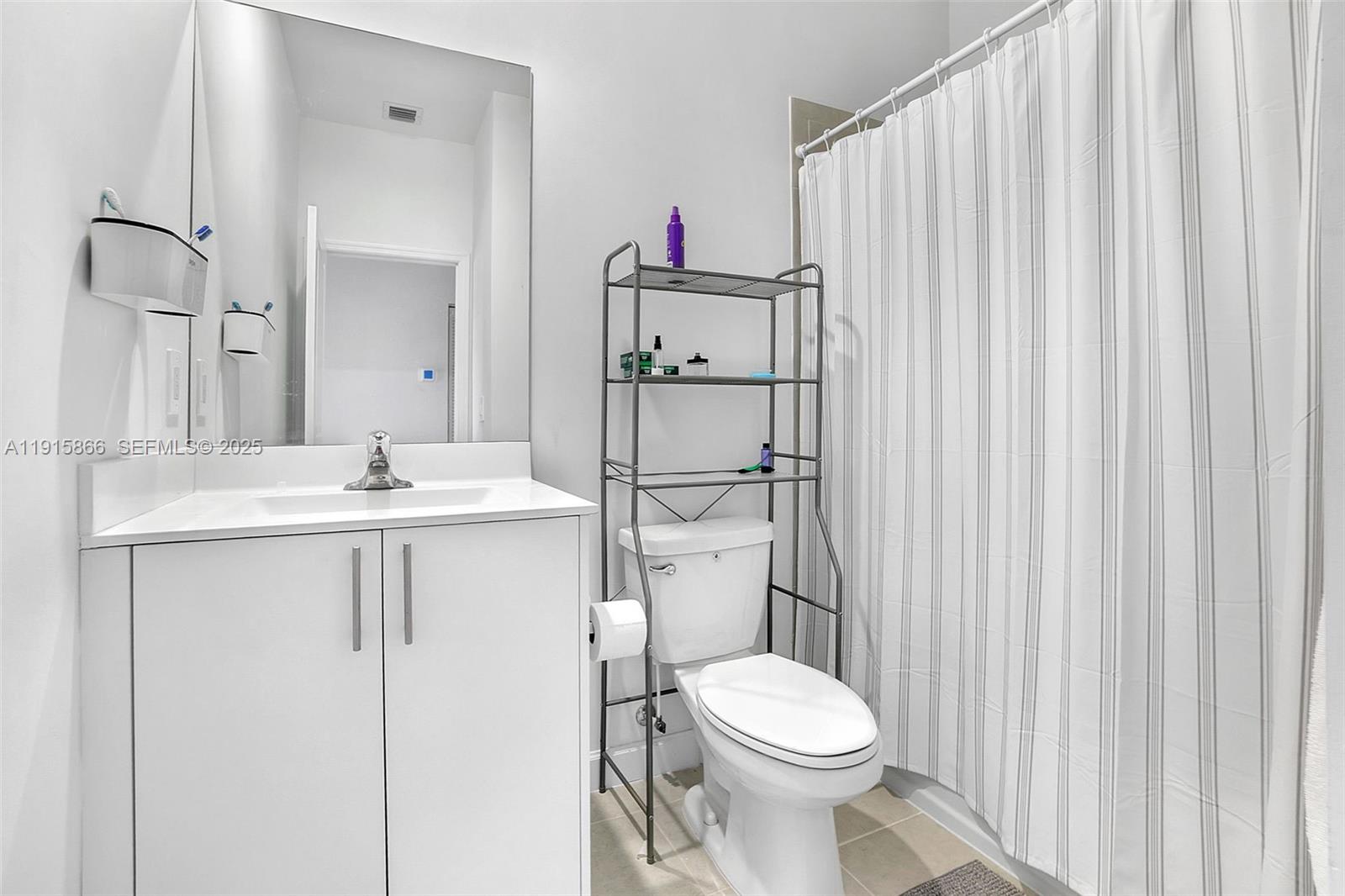 12859 Southwest 243rd Terrace Homestead, FL 33032 - Photo 23 of 38 a bathroom with a sink toilet and shower