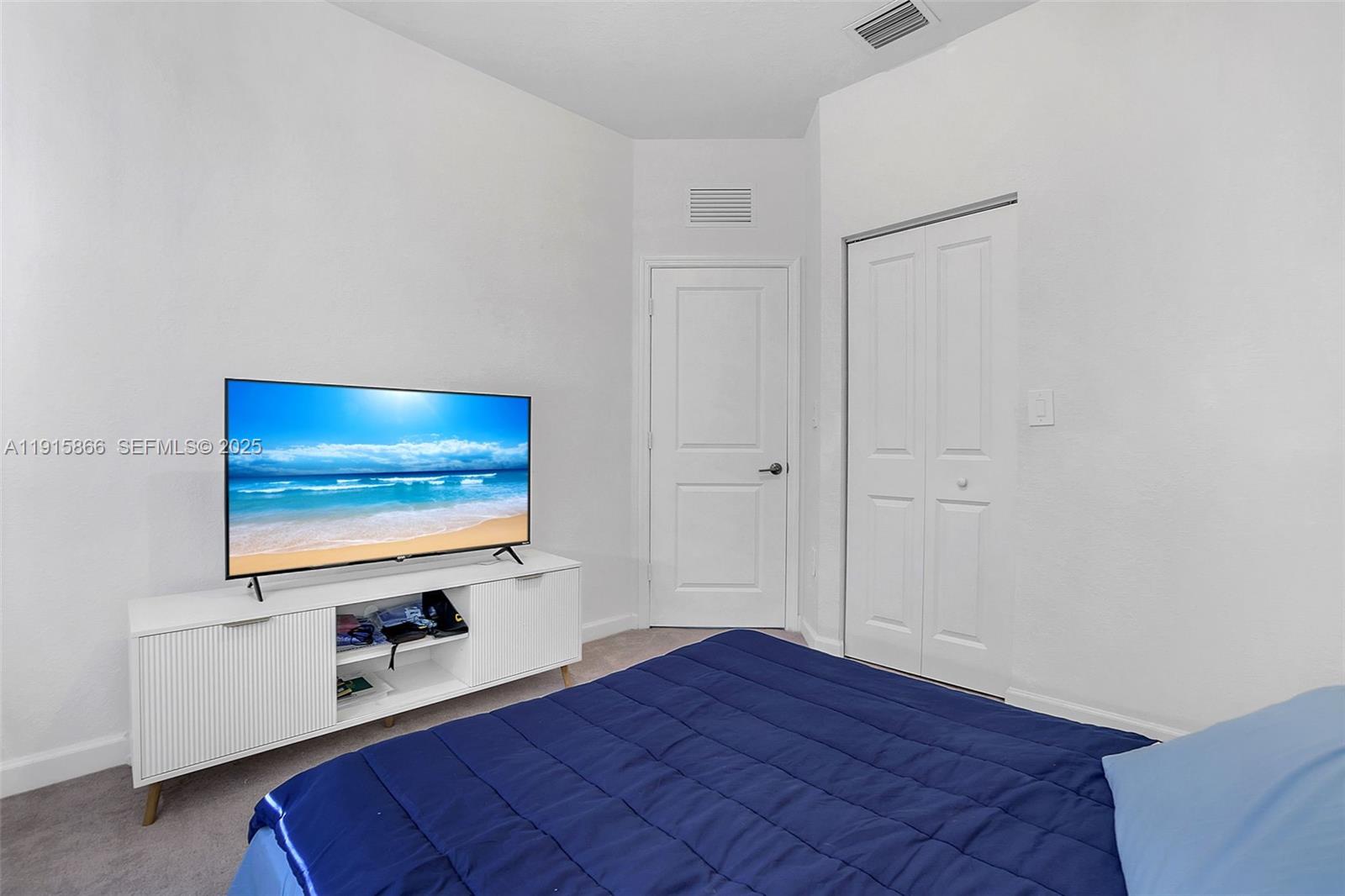 12859 Southwest 243rd Terrace Homestead, FL 33032 - Photo 25 of 38 a room with wooden floor and white walls