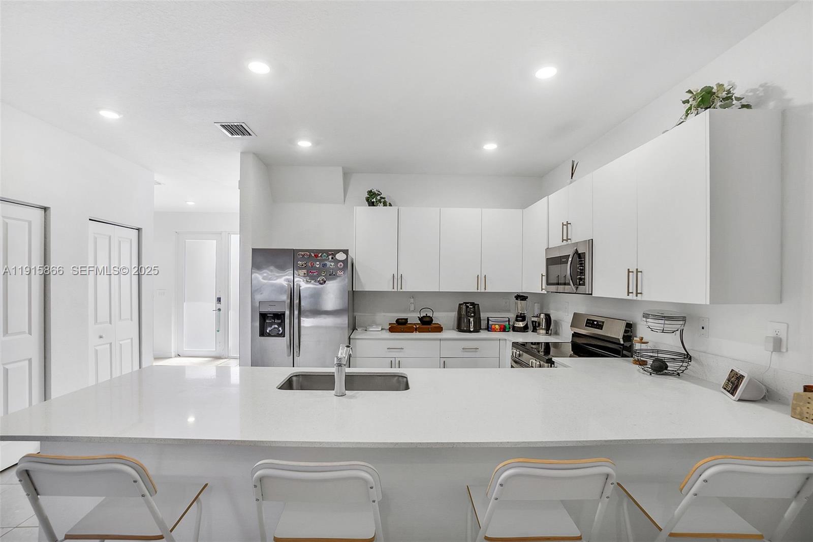 12859 Southwest 243rd Terrace Homestead, FL 33032 - Photo 3 of 38 a kitchen with stainless steel appliances granite countertop a refrigerator and a stove top oven