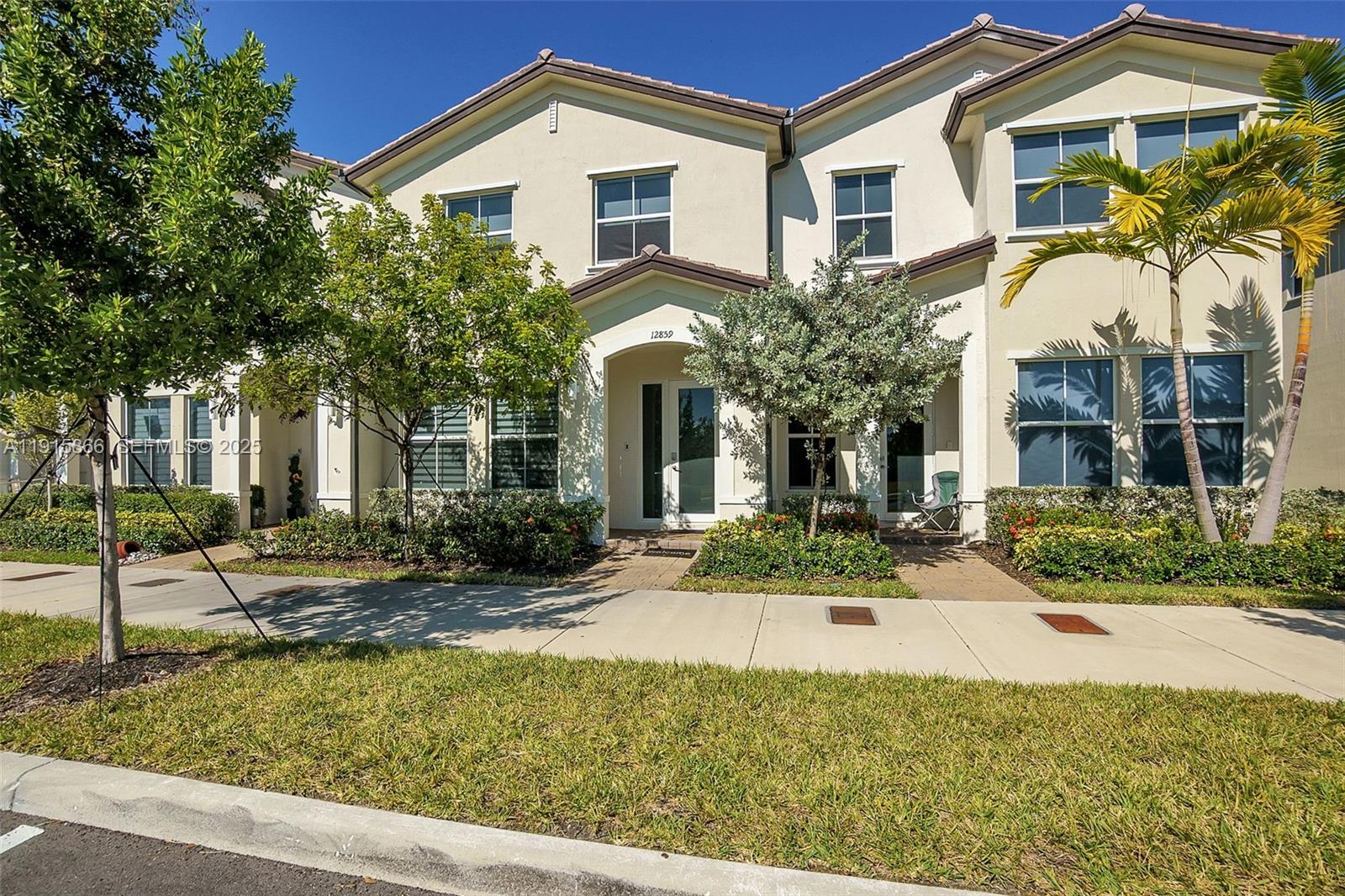 12859 Southwest 243rd Terrace Homestead, FL 33032 - Photo 31 of 38 a front view of a house with yard and green space