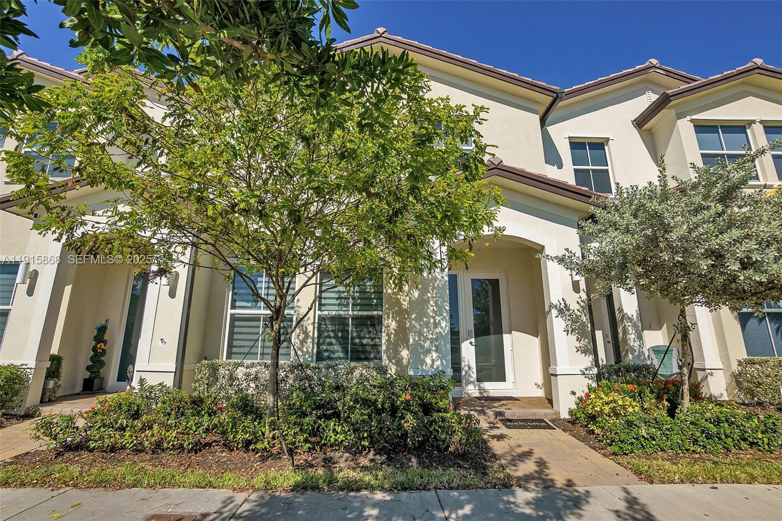 12859 Southwest 243rd Terrace Homestead, FL 33032 - Photo 32 of 38 front view of a house with a tree