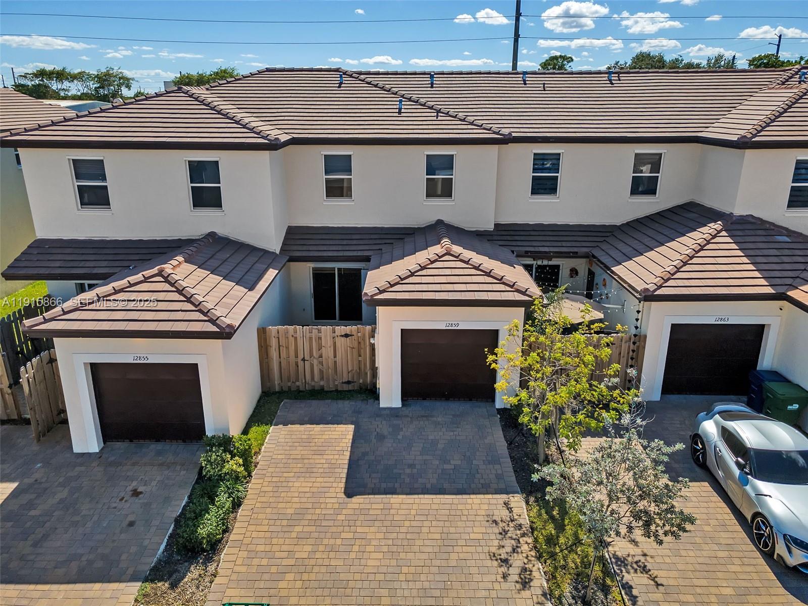 12859 Southwest 243rd Terrace Homestead, FL 33032 - Photo 33 of 38 a front view of a house with a garden