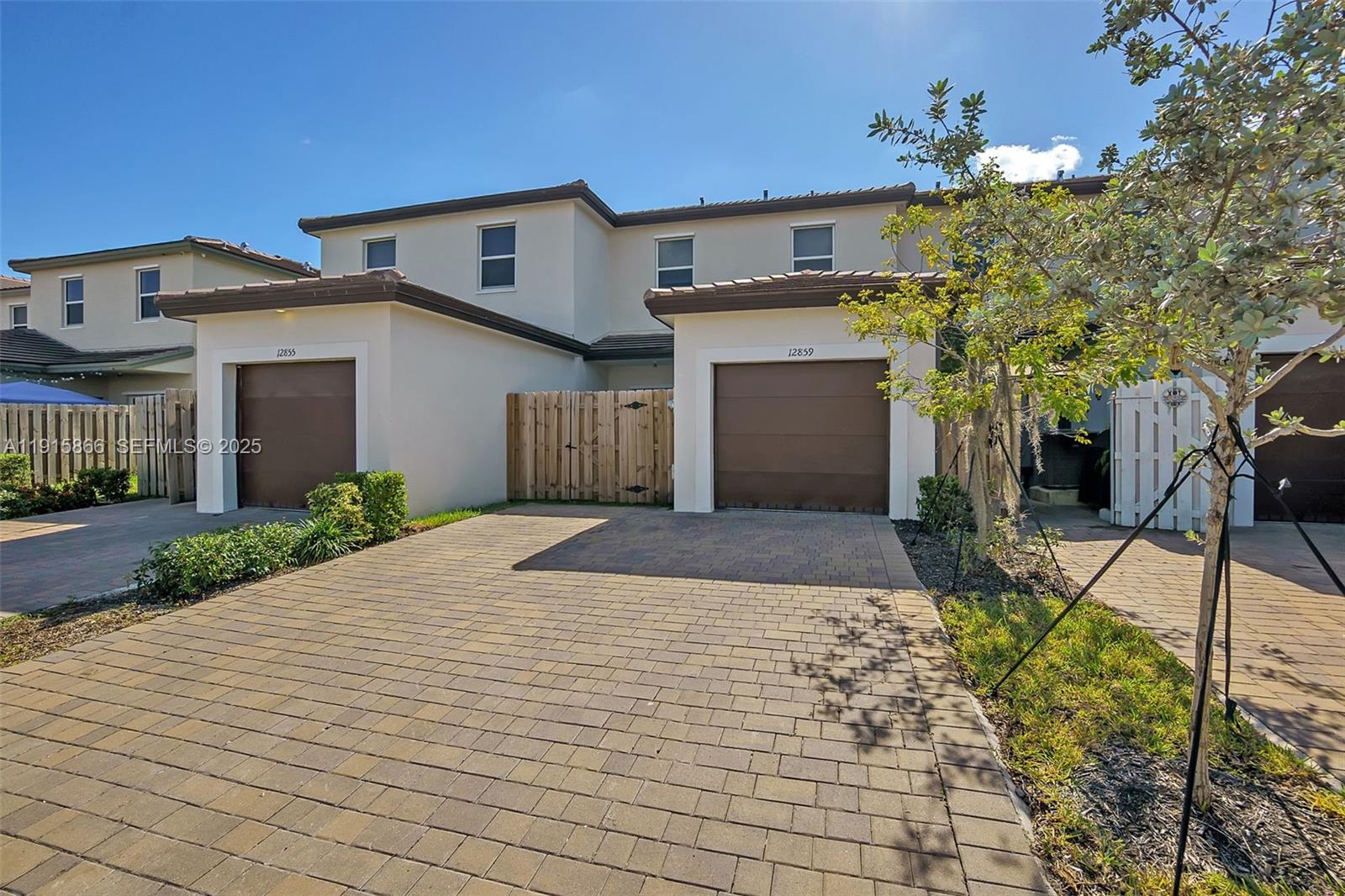 12859 Southwest 243rd Terrace Homestead, FL 33032 - Photo 36 of 38 a front view of a house with a yard and garage