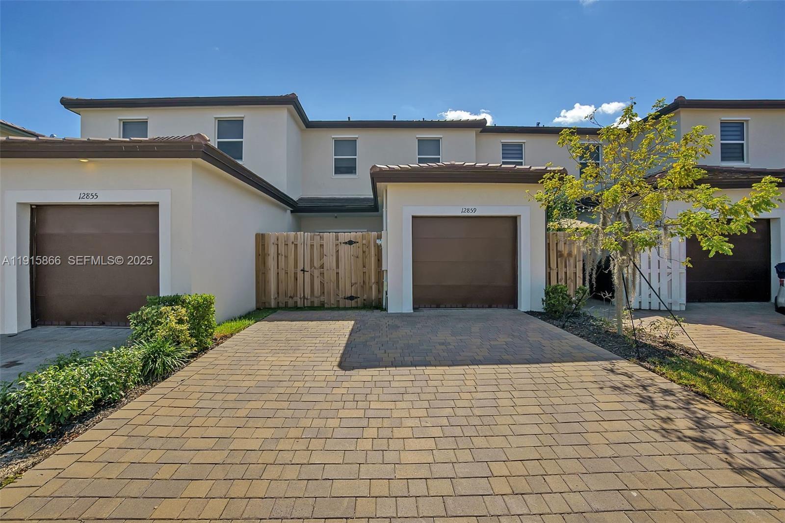 12859 Southwest 243rd Terrace Homestead, FL 33032 - Photo 37 of 38 a front view of a house with a yard and garage