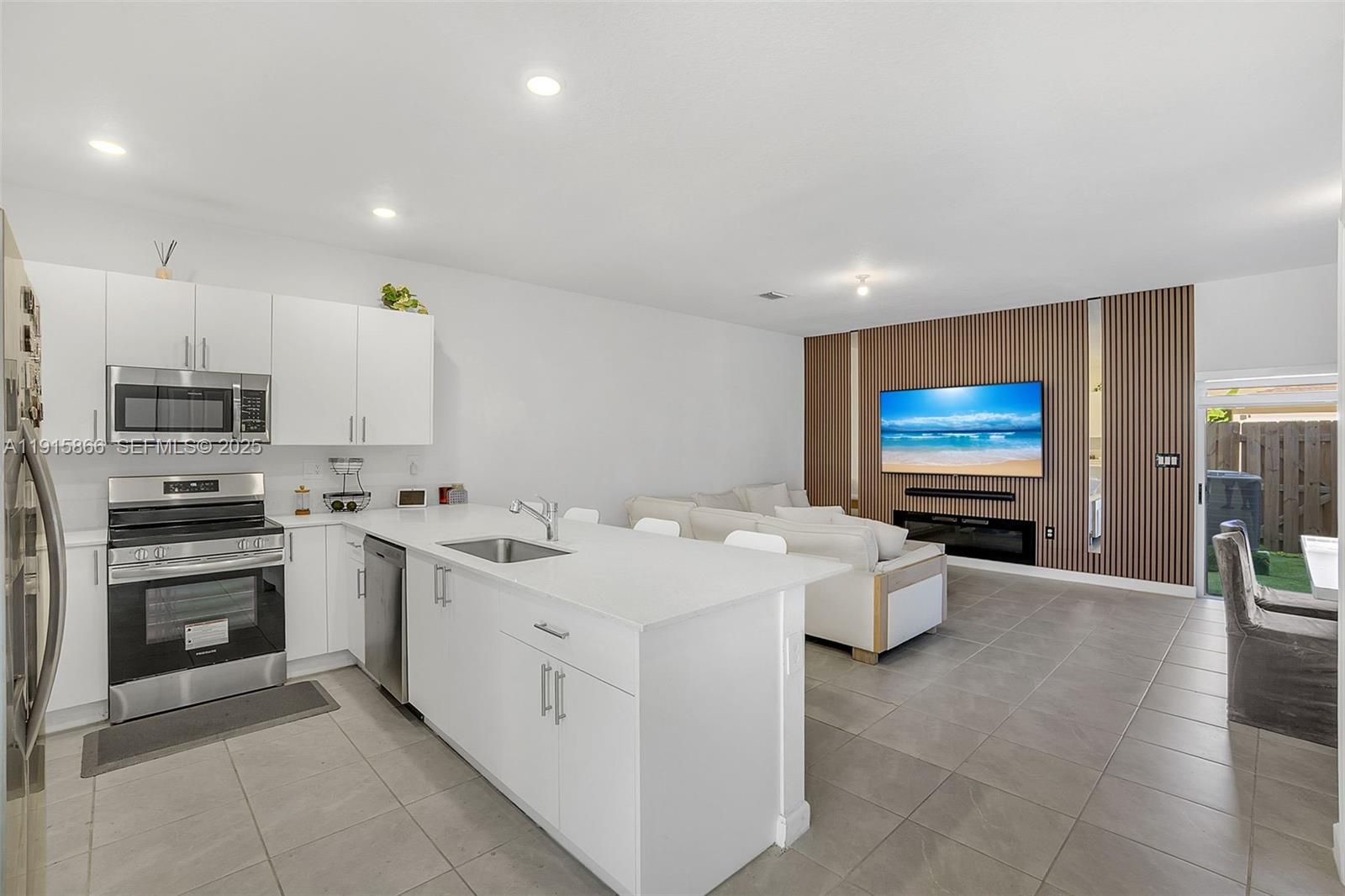 12859 Southwest 243rd Terrace Homestead, FL 33032 - Photo 4 of 38 a kitchen with stainless steel appliances a stove sink and microwave