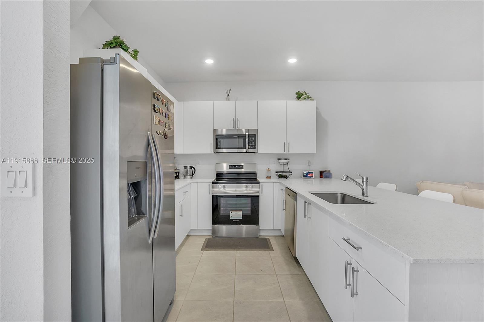 12859 Southwest 243rd Terrace Homestead, FL 33032 - Photo 6 of 38 a kitchen with stainless steel appliances a refrigerator stove and sink