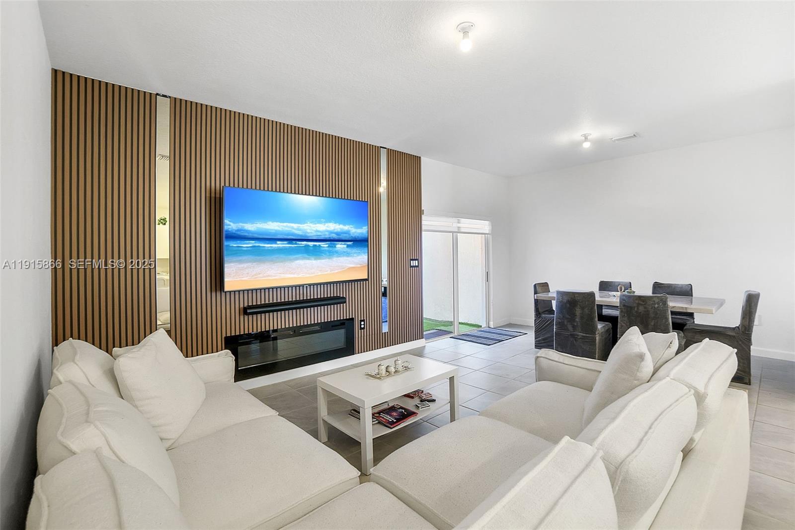 12859 Southwest 243rd Terrace Homestead, FL 33032 - Photo 8 of 38 a living room with furniture and a flat screen tv