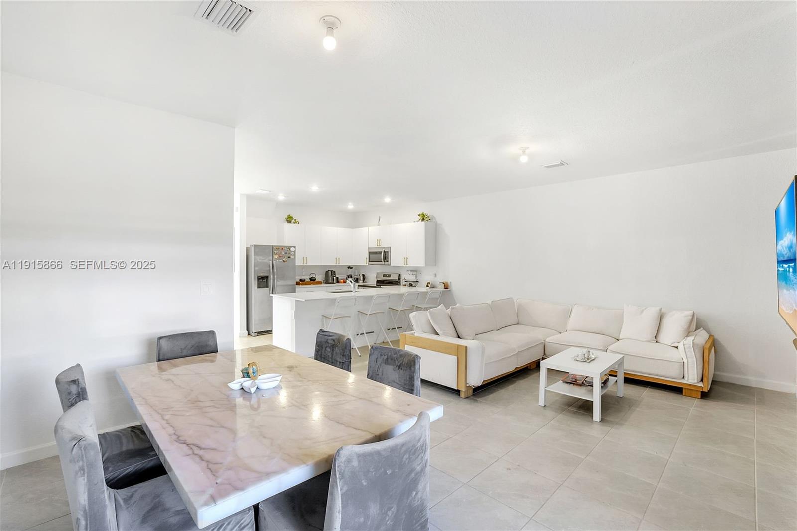 12859 Southwest 243rd Terrace Homestead, FL 33032 - Photo 10 of 38 a living room with furniture and a table