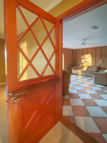 a living room with a open dining table and a large window