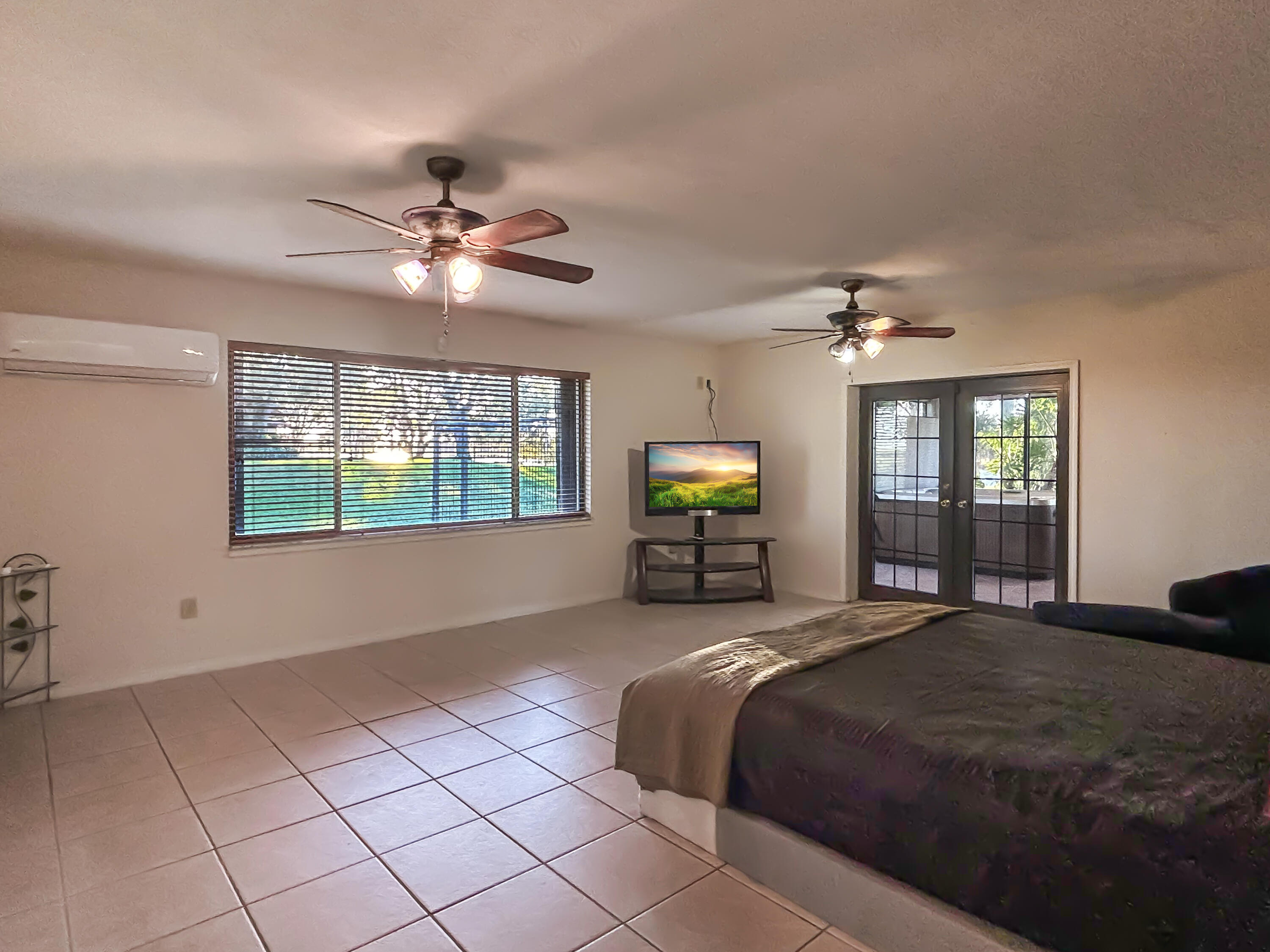 2531 River Road Moore Haven, FL 33471 - Photo 16 of 30 a spacious bedroom with a bed and a tv