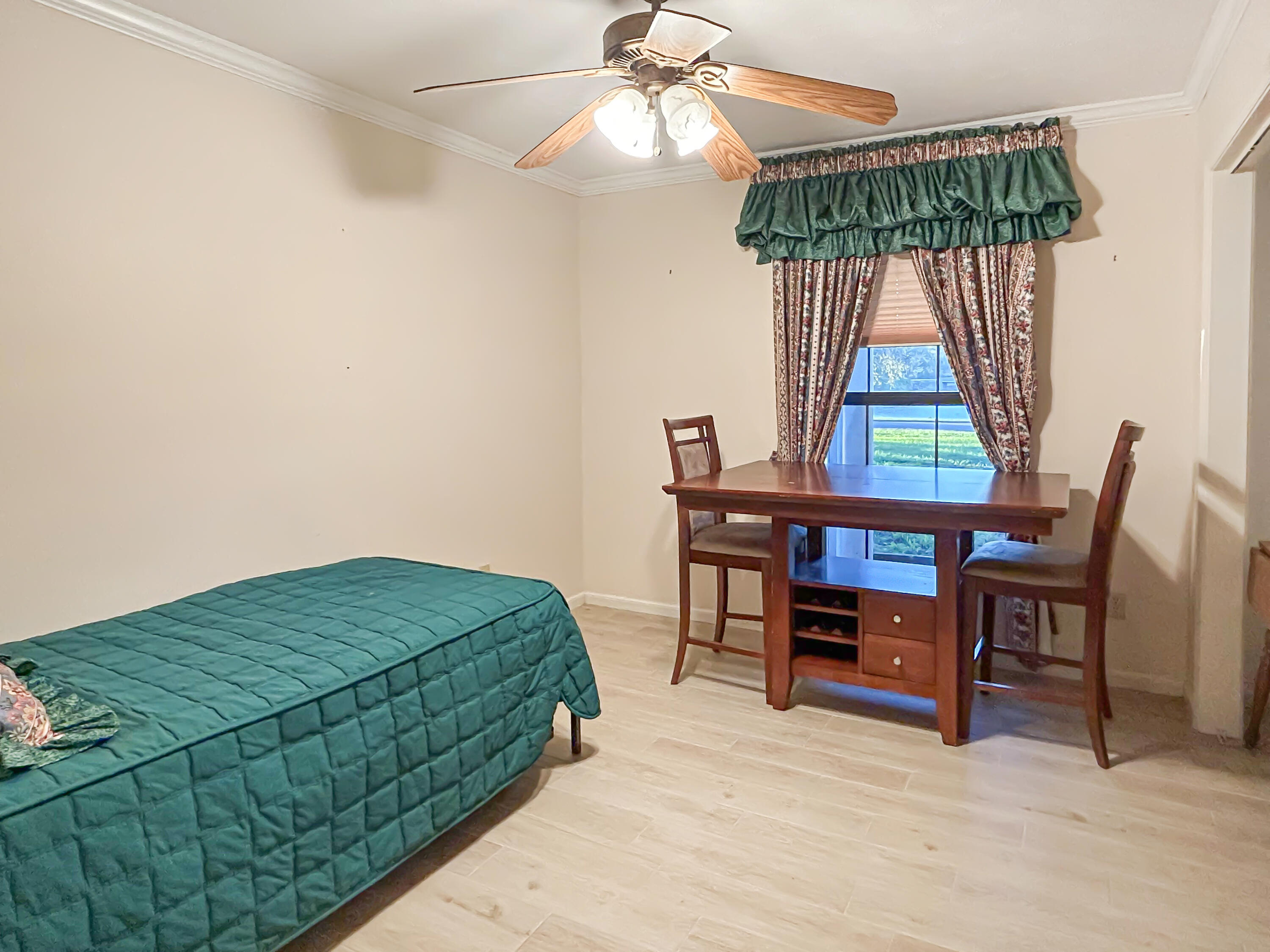 2531 River Road Moore Haven, FL 33471 - Photo 18 of 30 a bedroom with a bed and a chandelier