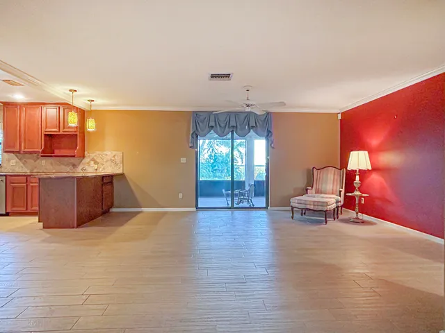 a living room with furniture and a kitchen
