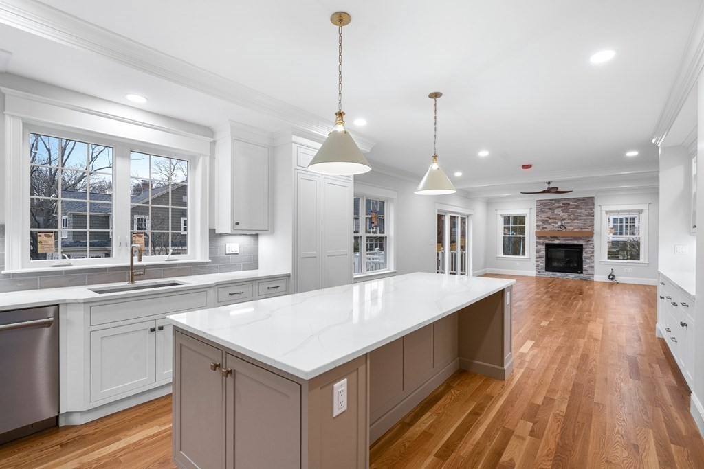 49 Allen Road Winchester, MA 01890 - Photo 12 of 38 a large kitchen with kitchen island a stove a sink a center island and wooden floor