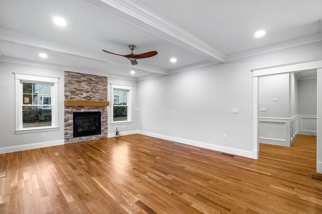 49 Allen Road Winchester, MA 01890 - Photo 19 of 38 an empty room with wooden floor fireplace and windows