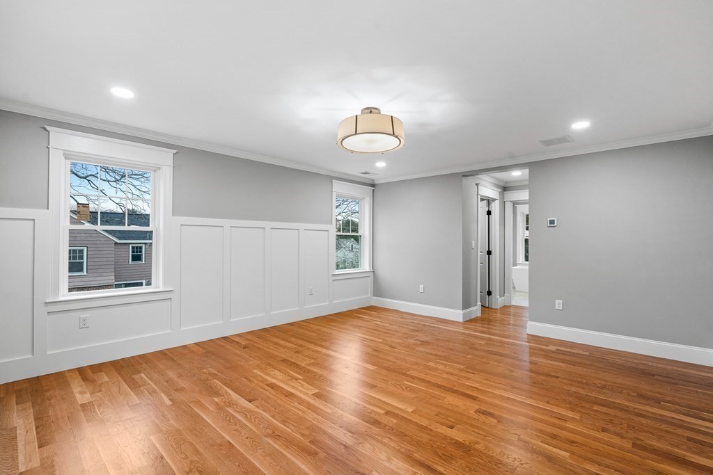 49 Allen Road Winchester, MA 01890 - Photo 21 of 38 a view of an empty room with wooden floor and a window