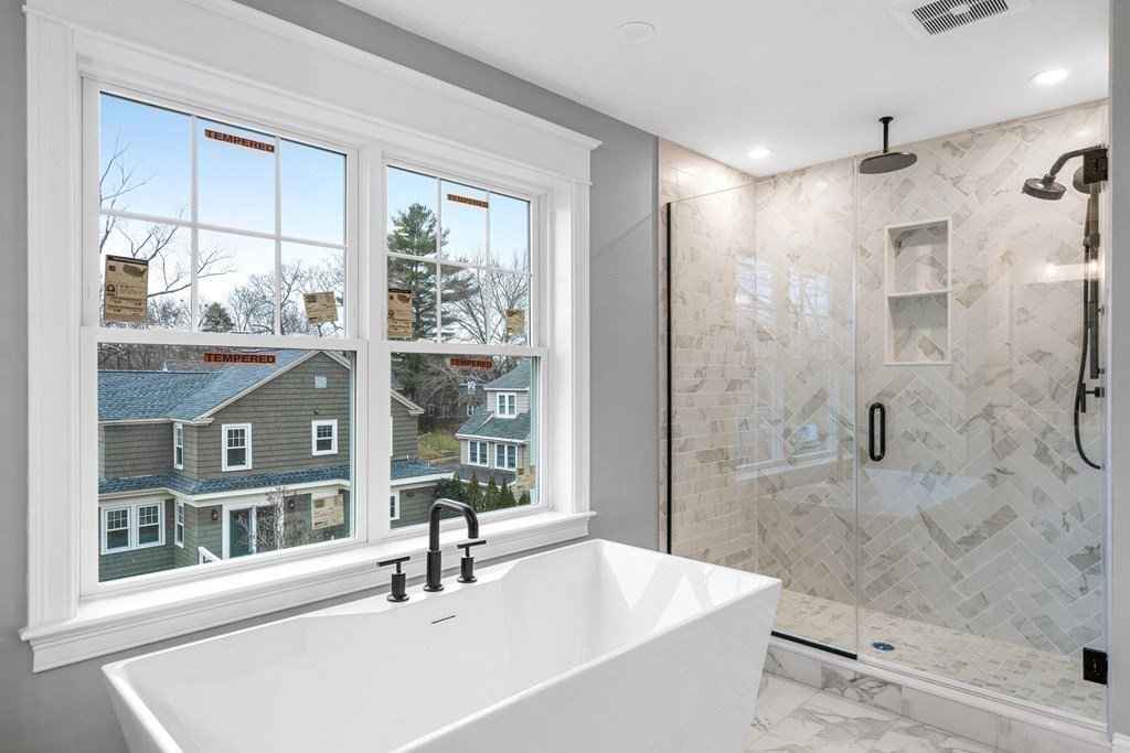 49 Allen Road Winchester, MA 01890 - Photo 24 of 38 a bathroom with a sink a bathtub and shower