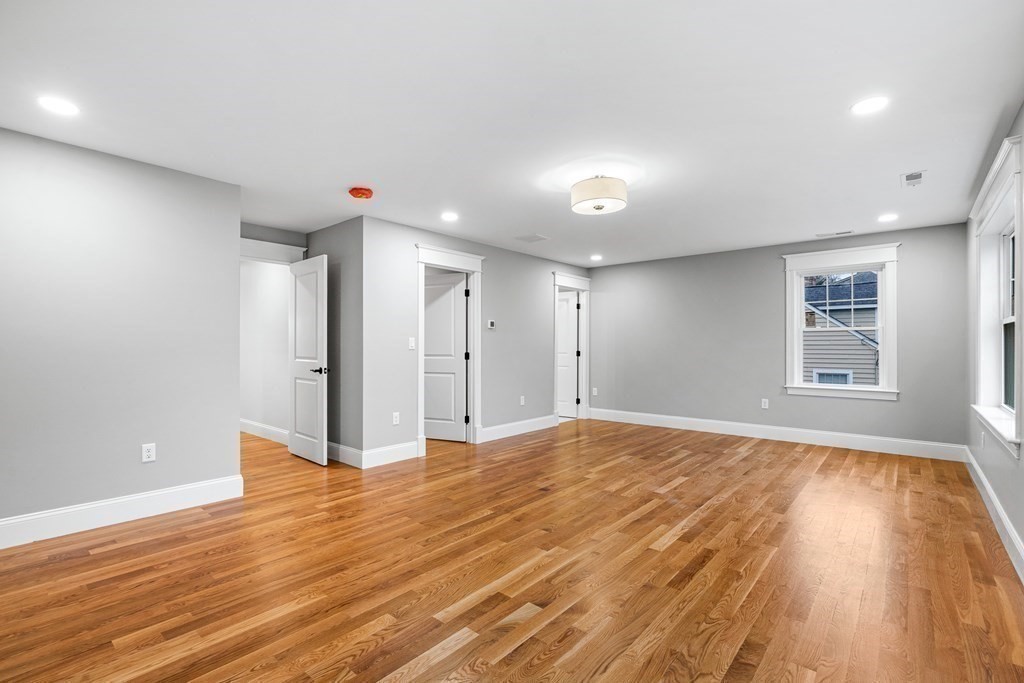 49 Allen Road Winchester, MA 01890 - Photo 25 of 38 a view of an empty room with wooden floor and a window