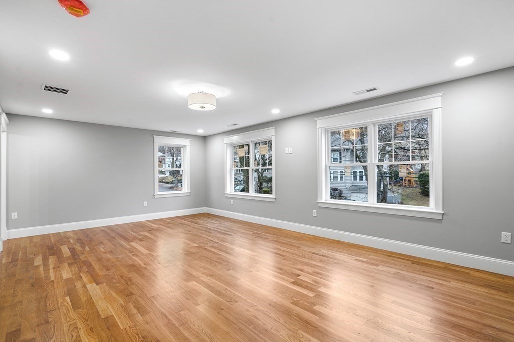 49 Allen Road Winchester, MA 01890 - Photo 26 of 38 a view of an empty room with a window and wooden floor