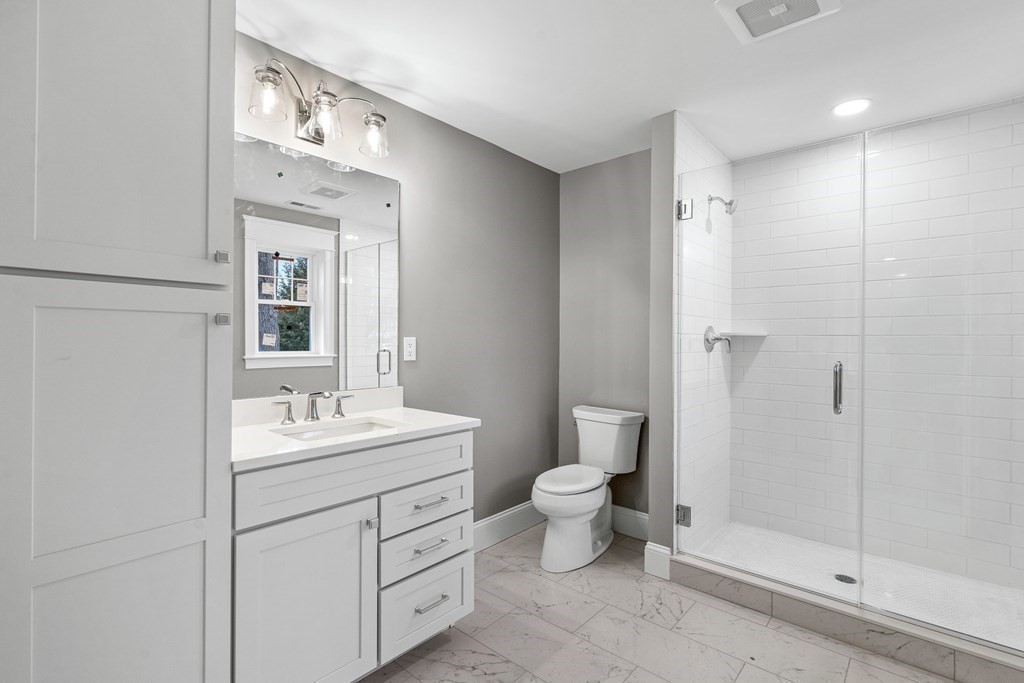 49 Allen Road Winchester, MA 01890 - Photo 27 of 38 a bathroom with a double vanity sink toilet and shower