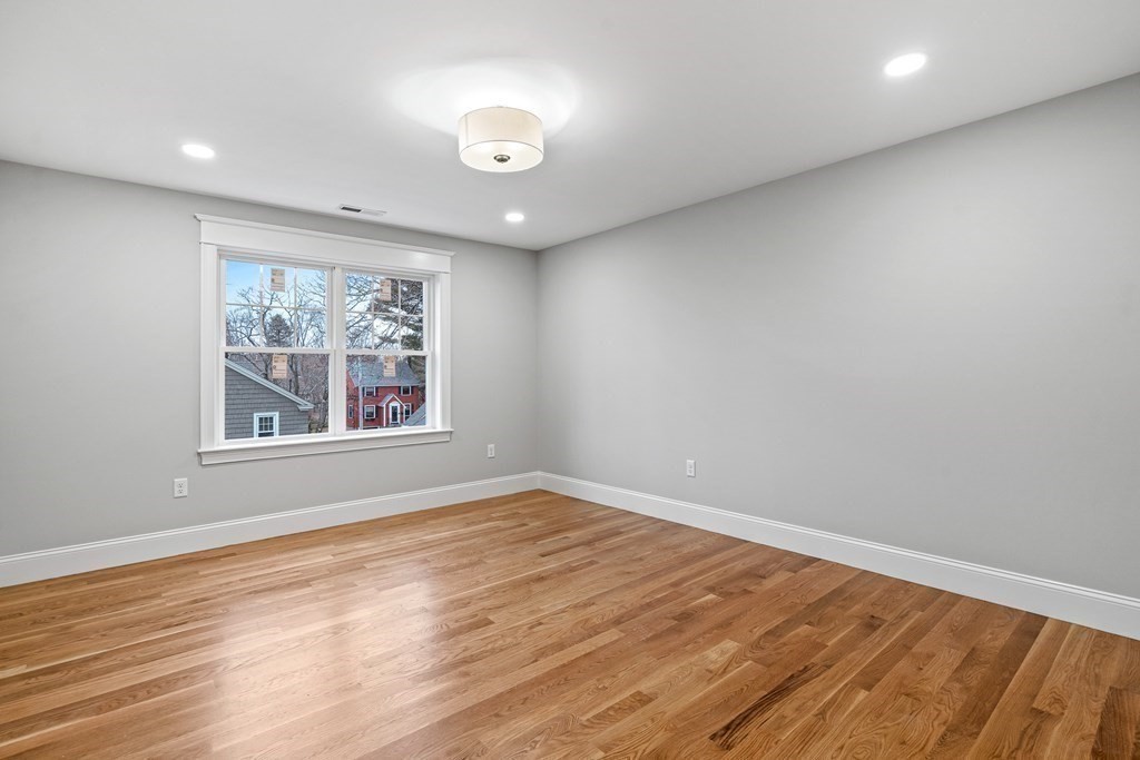 49 Allen Road Winchester, MA 01890 - Photo 30 of 38 an empty room with wooden floor and window