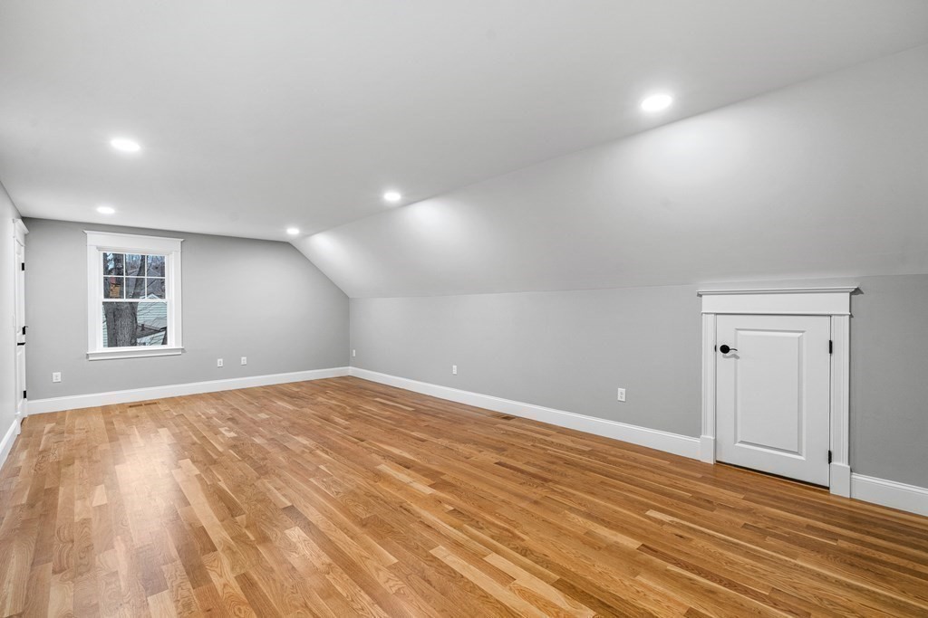 49 Allen Road Winchester, MA 01890 - Photo 31 of 38 a view of an empty room with wooden floor and a window