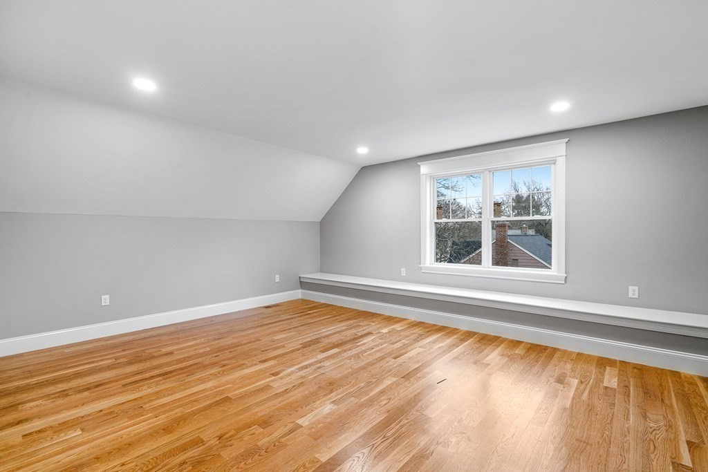 49 Allen Road Winchester, MA 01890 - Photo 32 of 38 a view of an empty room with a window and wooden floor