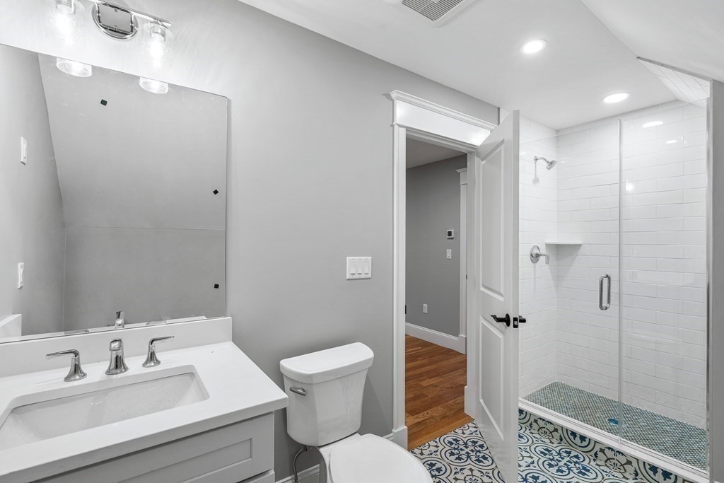 49 Allen Road Winchester, MA 01890 - Photo 33 of 38 a bathroom with a sink and a mirror