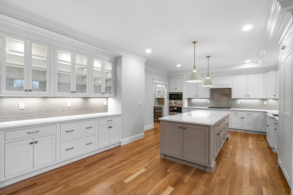 49 Allen Road Winchester, MA 01890 - Photo 4 of 38 a large kitchen with kitchen island white cabinets and stainless steel appliances