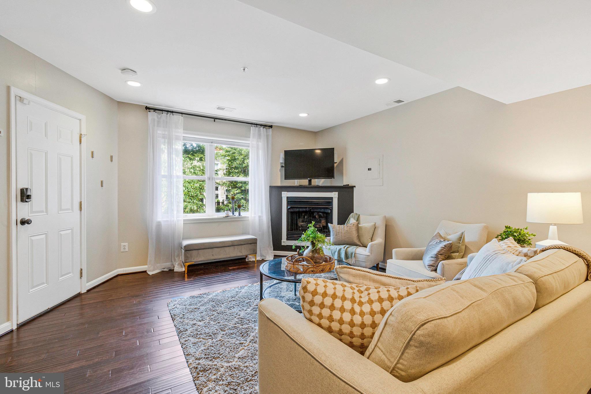 1519 Constitution Avenue Northeast, Unit 101 Washington, DC 20002 - Photo 3 of 32 a living room with furniture and a fireplace