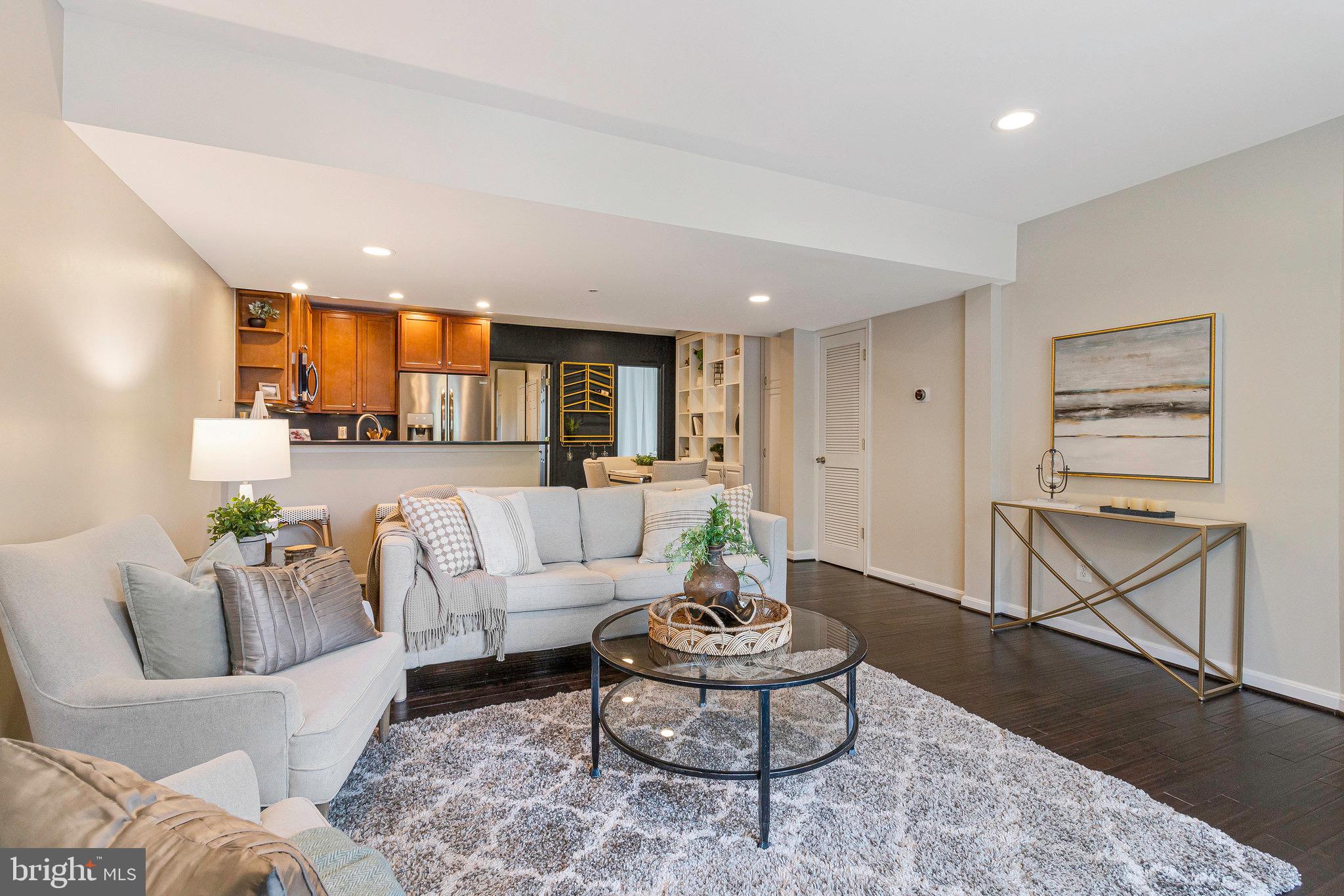 1519 Constitution Avenue Northeast, Unit 101 Washington, DC 20002 - Photo 5 of 32 a living room with furniture and wooden floor