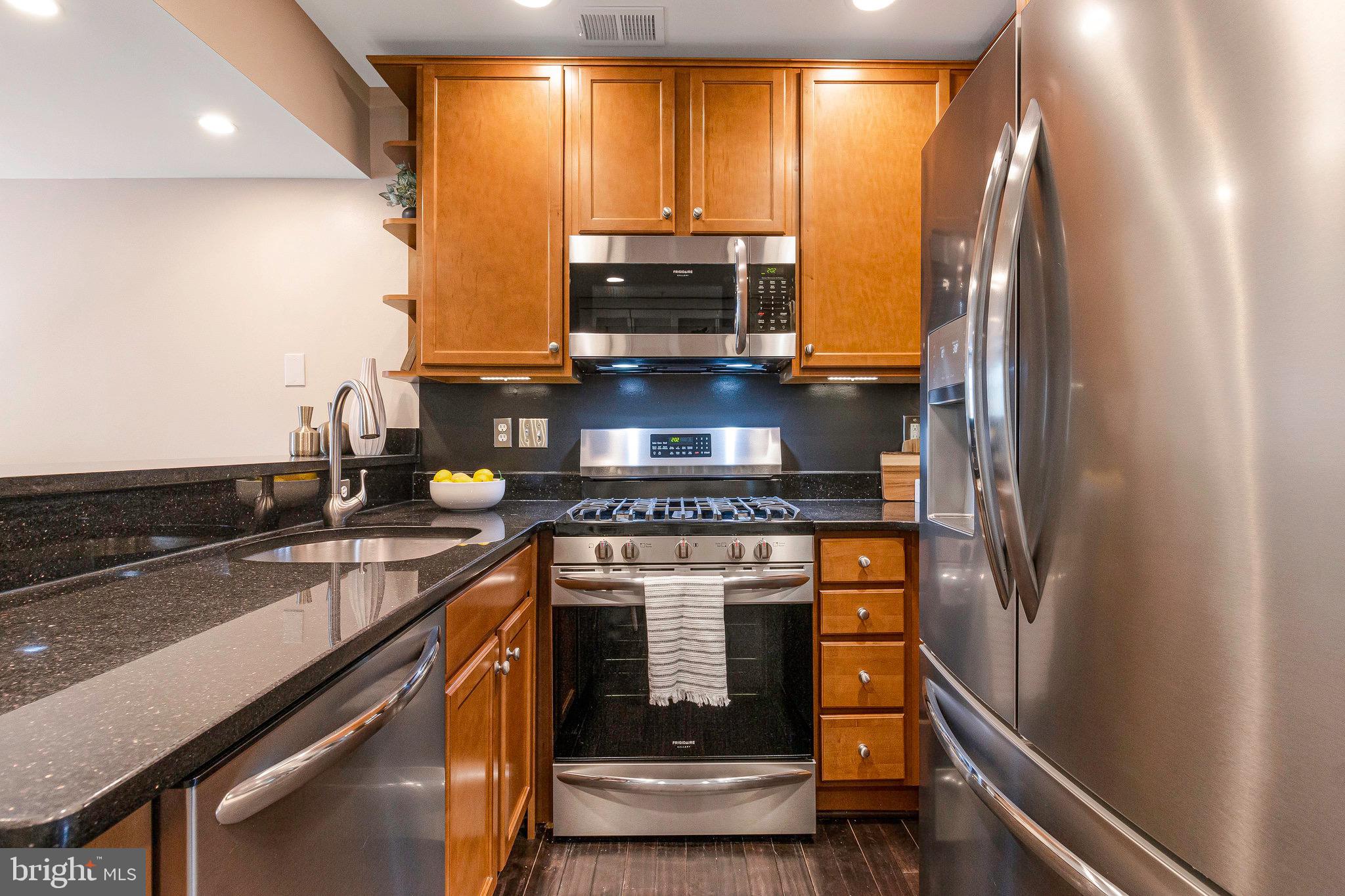 1519 Constitution Avenue Northeast, Unit 101 Washington, DC 20002 - Photo 7 of 32 a kitchen with a stove and a refrigerator
