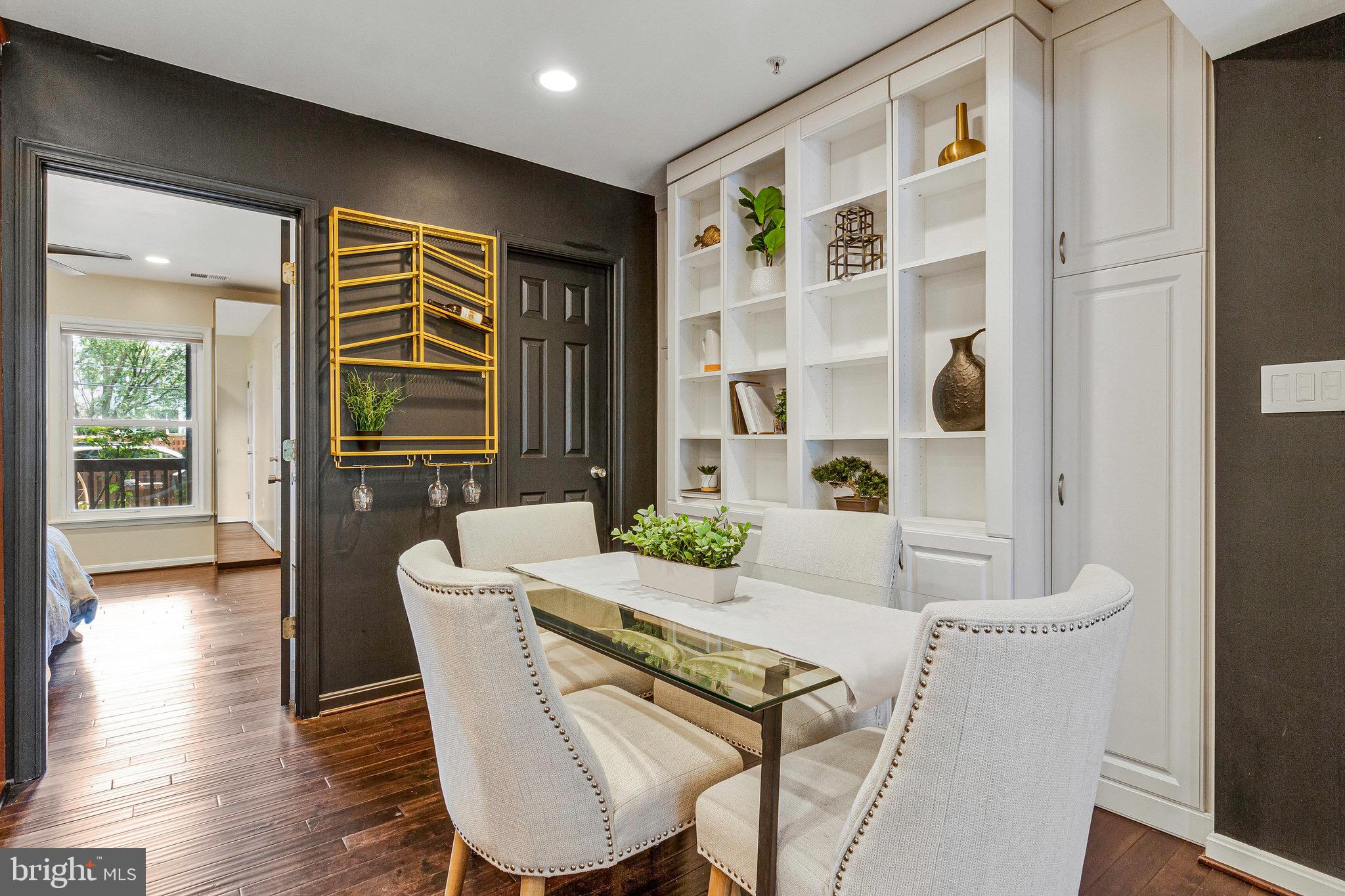 1519 Constitution Avenue Northeast, Unit 101 Washington, DC 20002 - Photo 9 of 32 a dining room with furniture and wooden floor