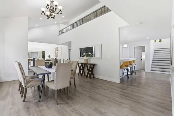 a view of a dining room with furniture and chandelier