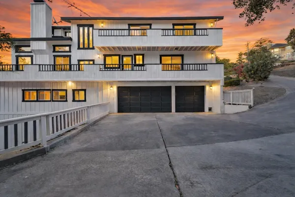 a front view of a house with glass doors and garage