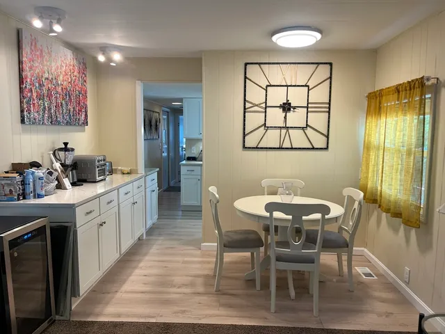 a large kitchen with a table and chairs