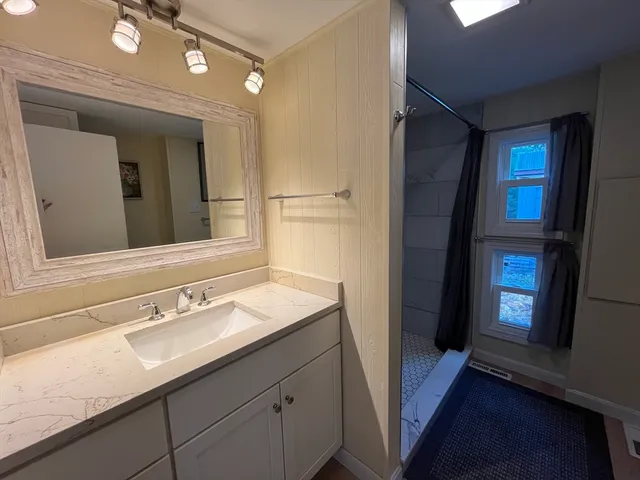 a bathroom with a sink and a mirror