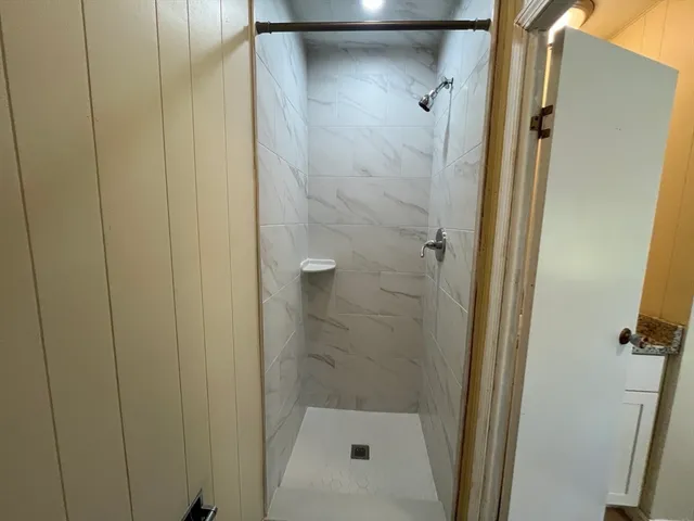 a bathroom with a glass door shower