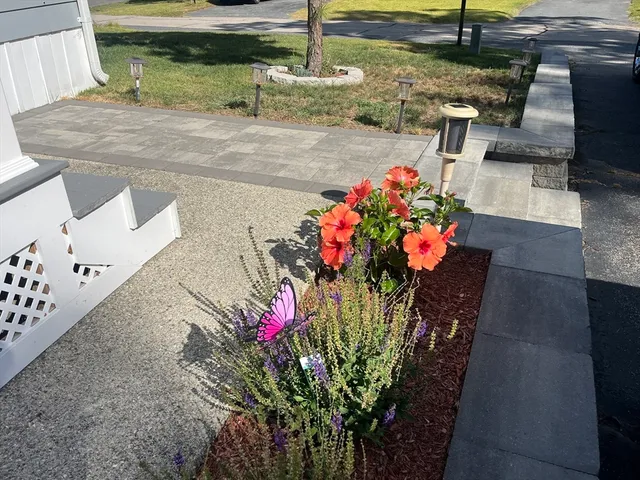 a flower pot with wooden fence