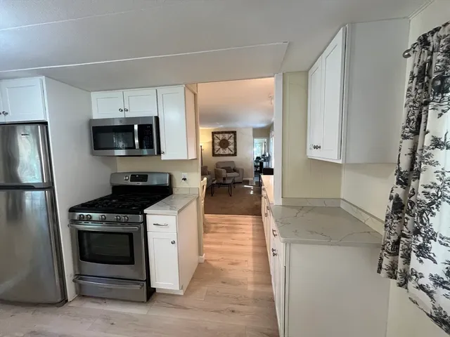 a kitchen with a stove and a refrigerator