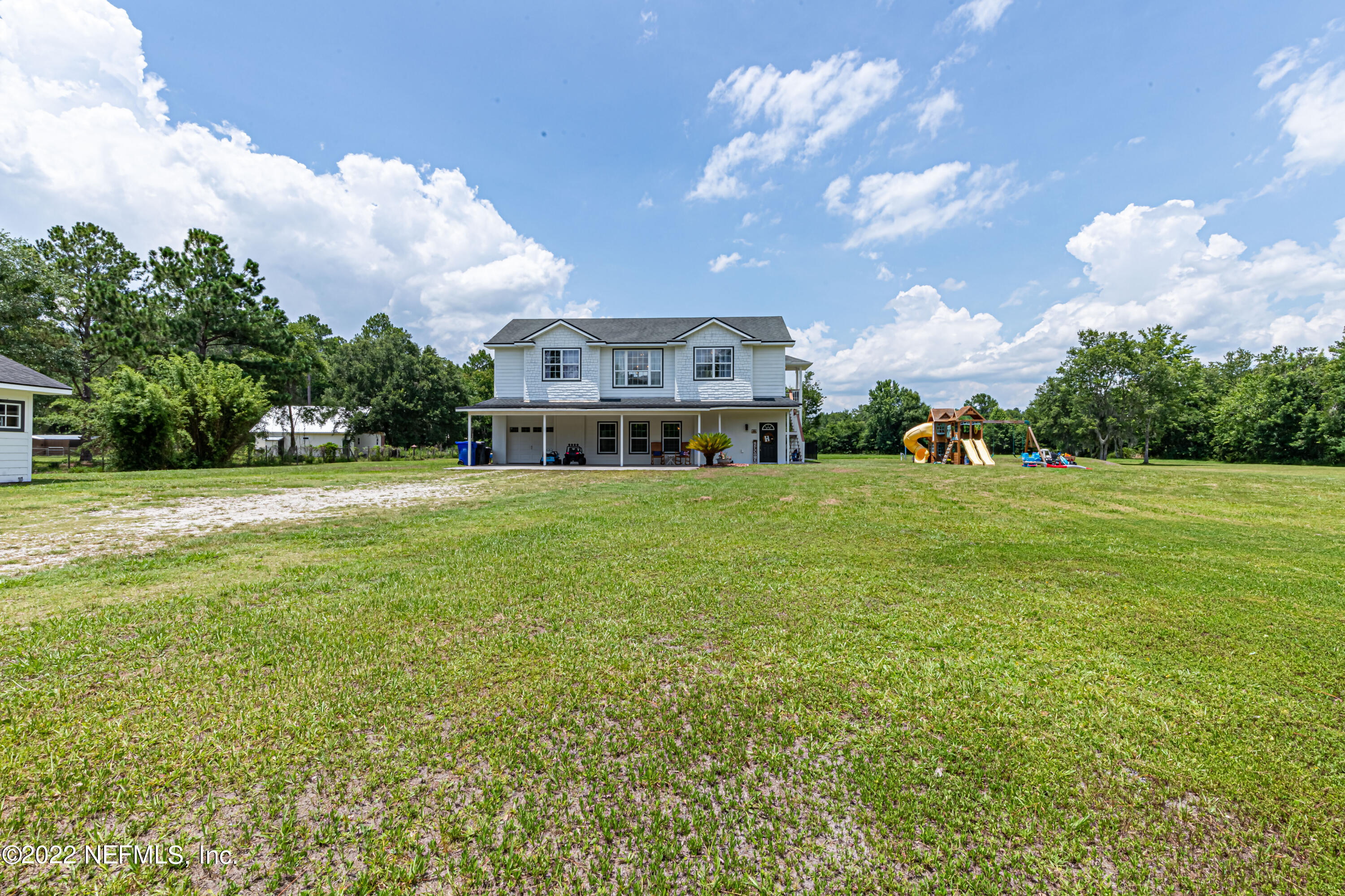 1830 Bennett Road St. Augustine, FL 32092 - Photo 28 of 45 a view of a house with a big yard and large trees