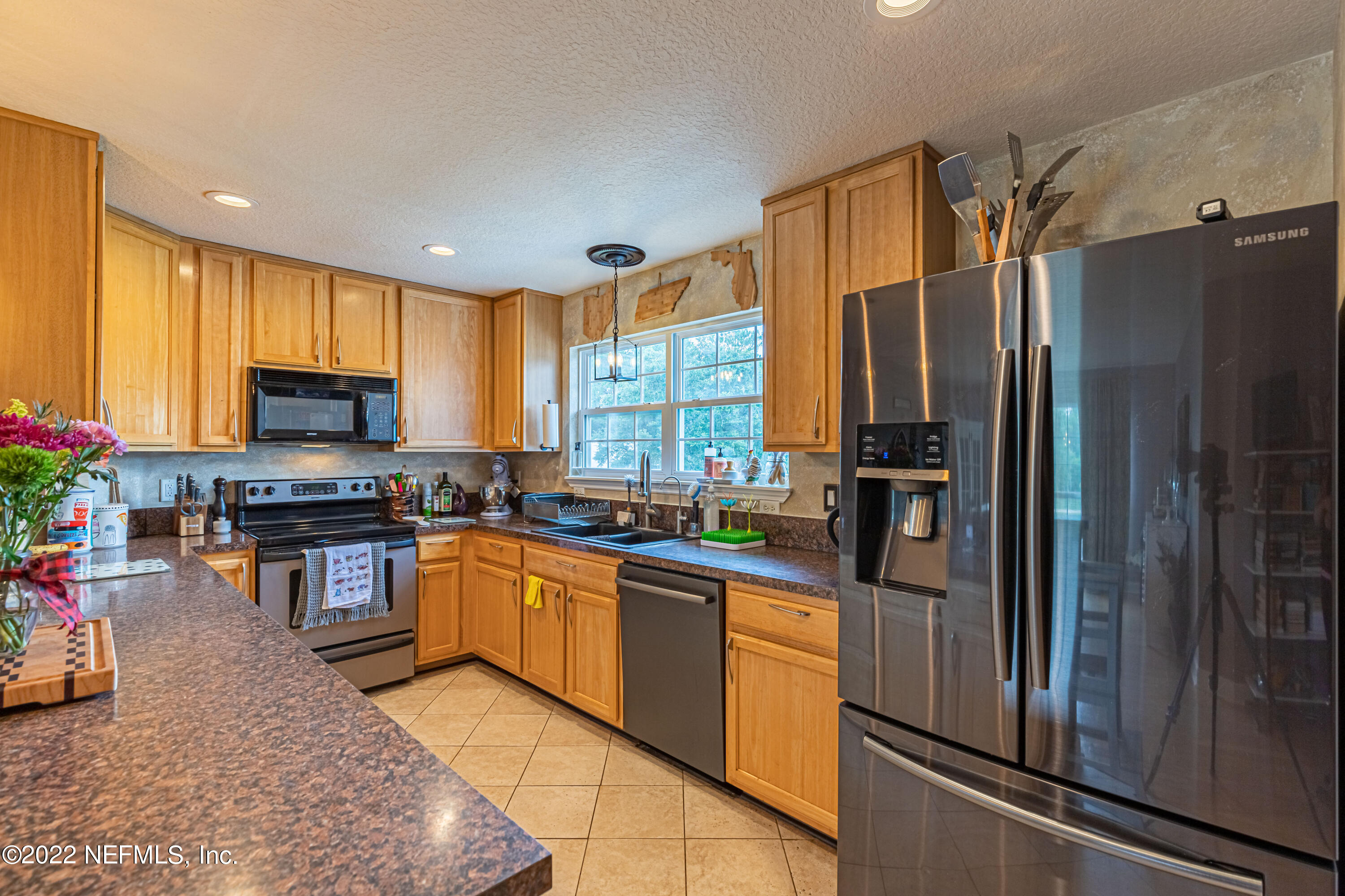 1830 Bennett Road St. Augustine, FL 32092 - Photo 35 of 45 a kitchen with granite countertop stainless steel appliances and wooden cabinets