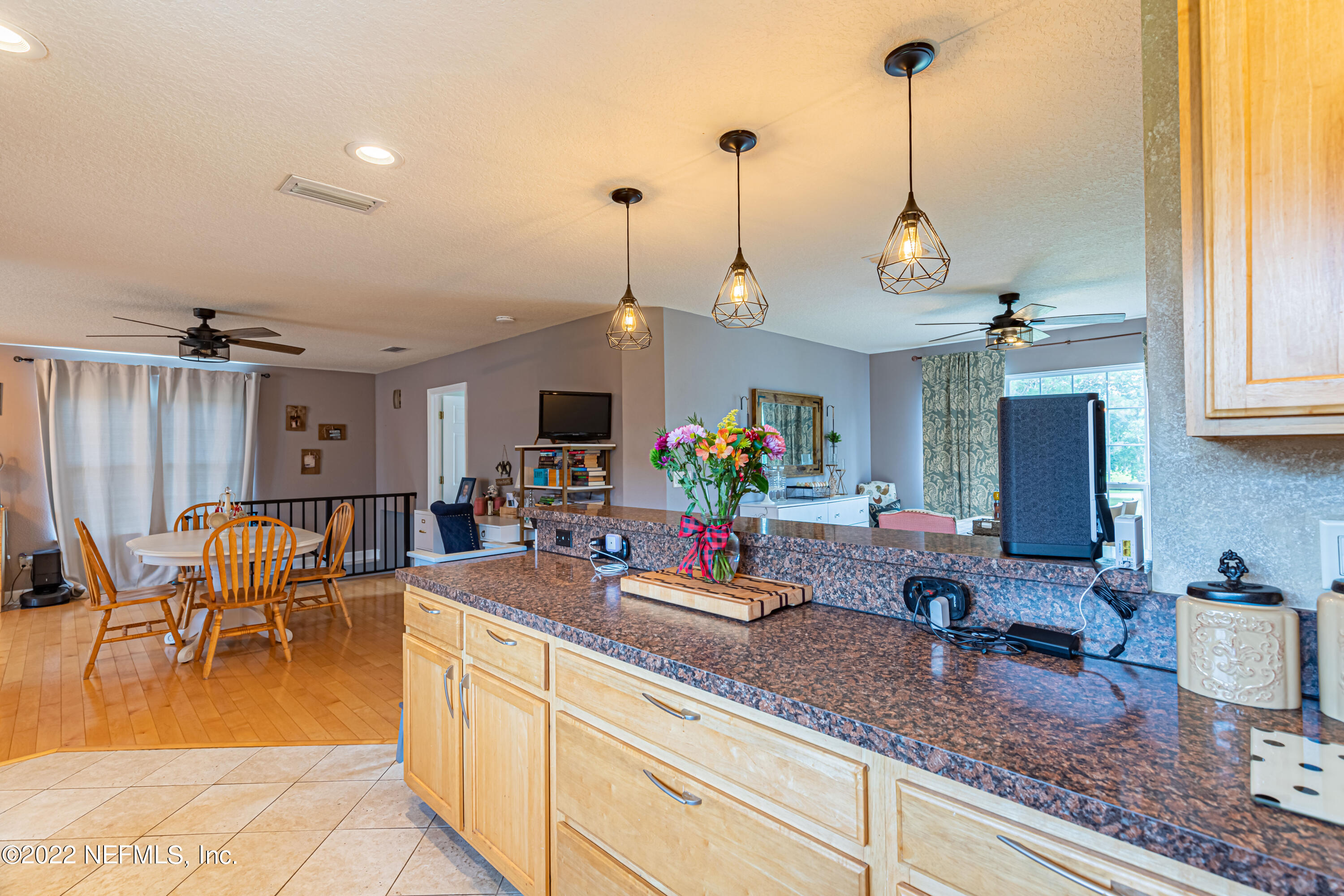 1830 Bennett Road St. Augustine, FL 32092 - Photo 36 of 45 a view of a kitchen with kitchen island granite countertop a sink a counter top space and living room view