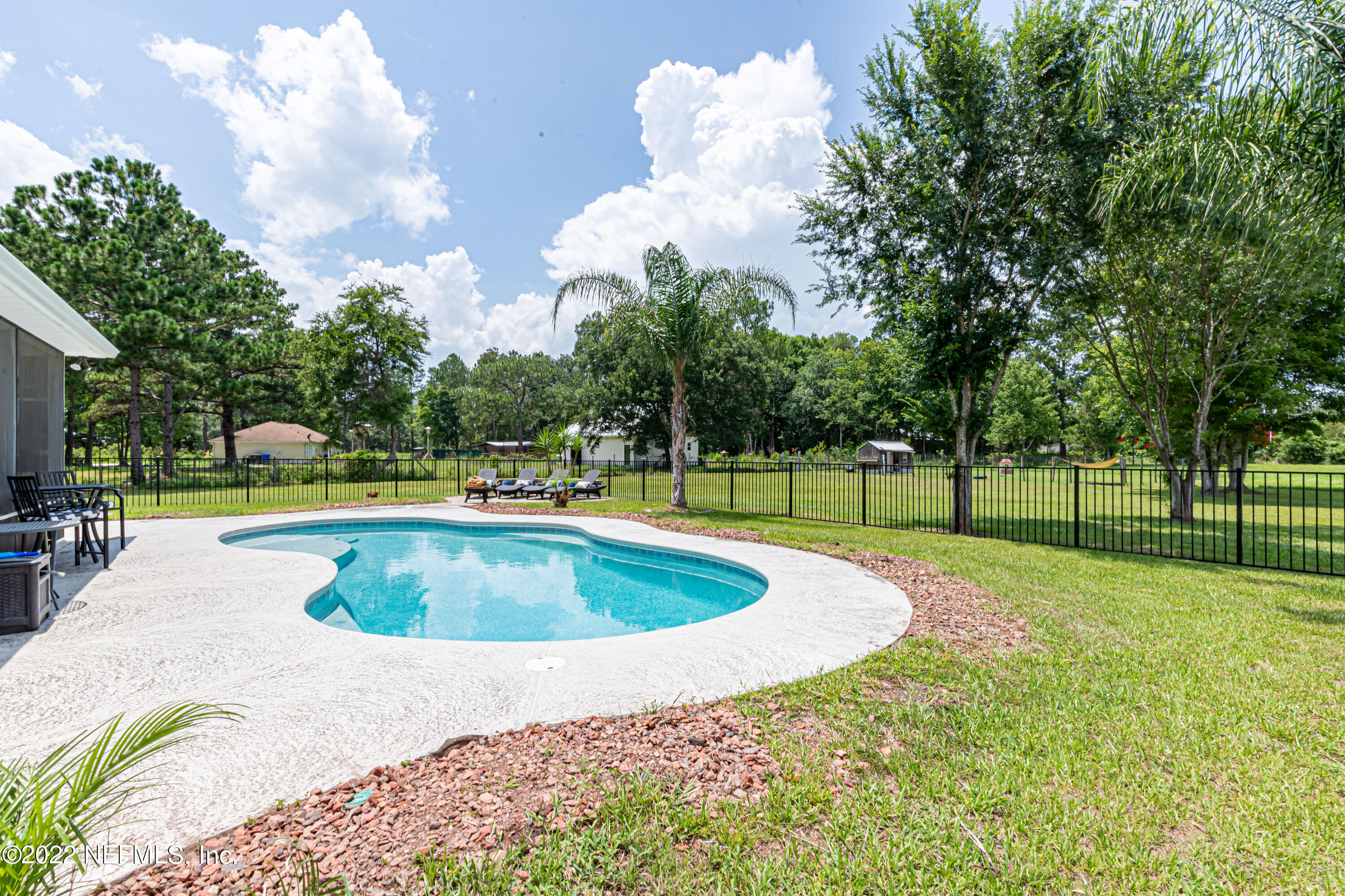 1830 Bennett Road St. Augustine, FL 32092 - Photo 7 of 45 a view of a swimming pool with a yard