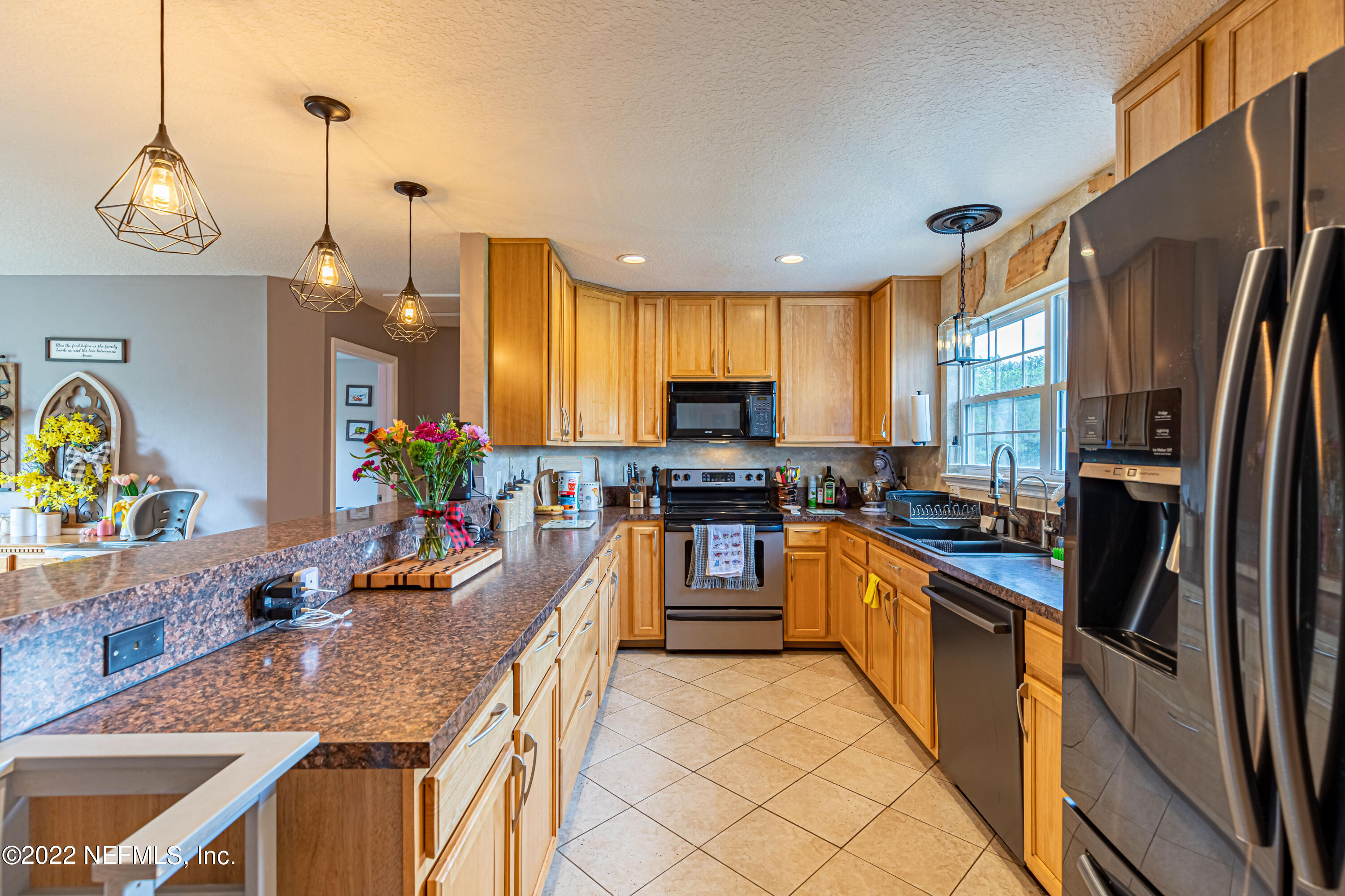 1830 Bennett Road St. Augustine, FL 32092 - Photo 8 of 45 a kitchen with stainless steel appliances granite countertop sink stove top oven and refrigerator