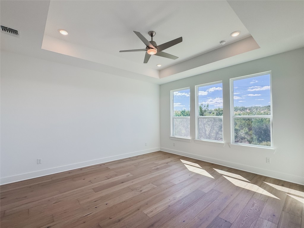 712 Iron Willow Loop Dripping Springs, TX 78620 - Photo 11 of 30 wooden floor in an empty room with a window