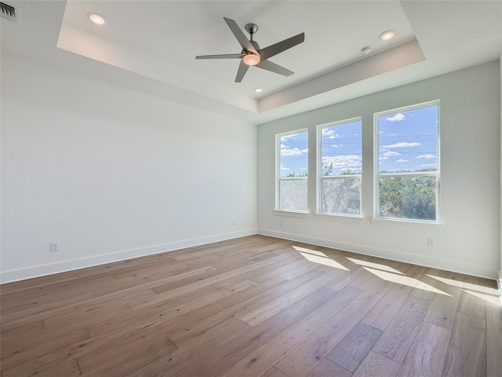712 Iron Willow Loop Dripping Springs, TX 78620 - Photo 12 of 30 an empty room with wooden floor and windows