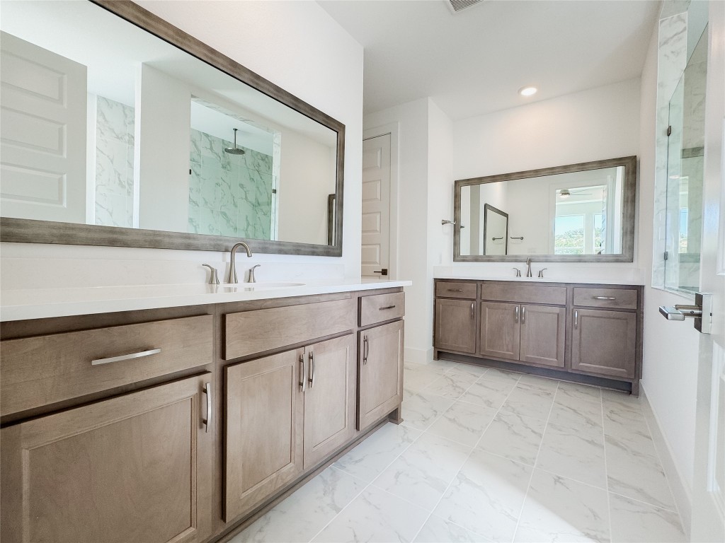 712 Iron Willow Loop Dripping Springs, TX 78620 - Photo 14 of 30 a bathroom with a sink double vanity and a mirror